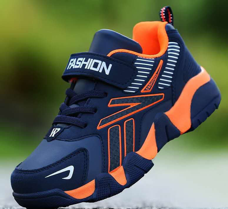 A pair of kids' sport sneakers with a black and white design, featuring a lace-up closure and the word 'FASHION' printed on the side.