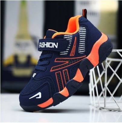 A pair of kids' sport sneakers with a black and white design, featuring a lace-up closure and the word 'FASHION' printed on the side.