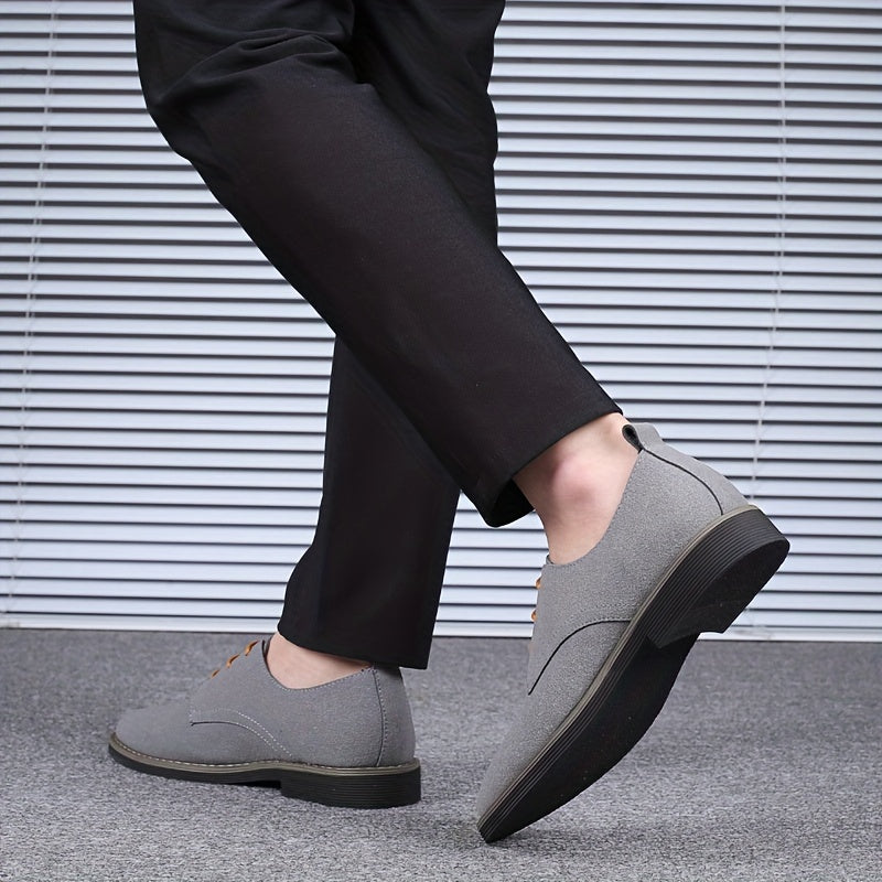 Person wearing gray shoes and black pants against a striped background