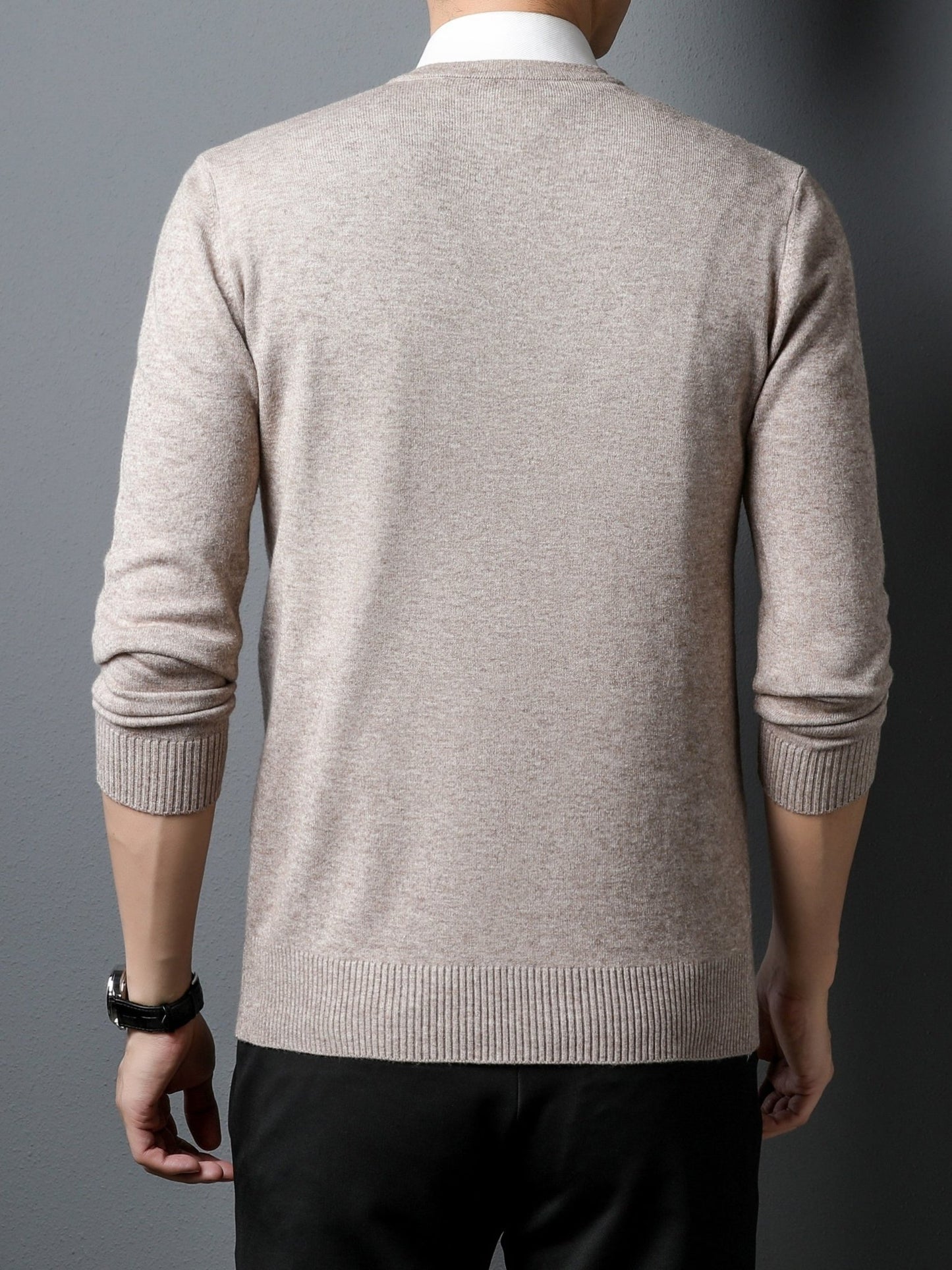 Man wearing a beige Men's Knitted V-neck Sweater on a gray background