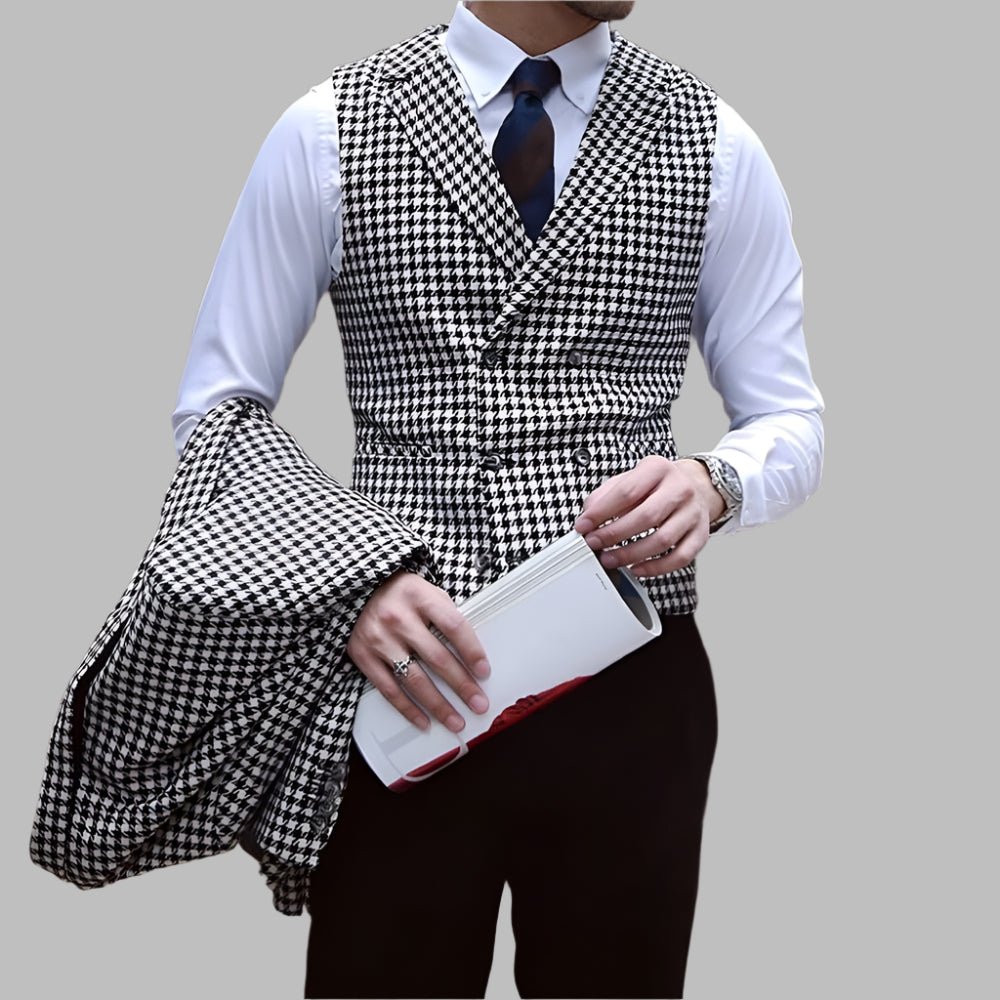 Person wearing a houndstooth pattern vest over a white shirt with a gray background
