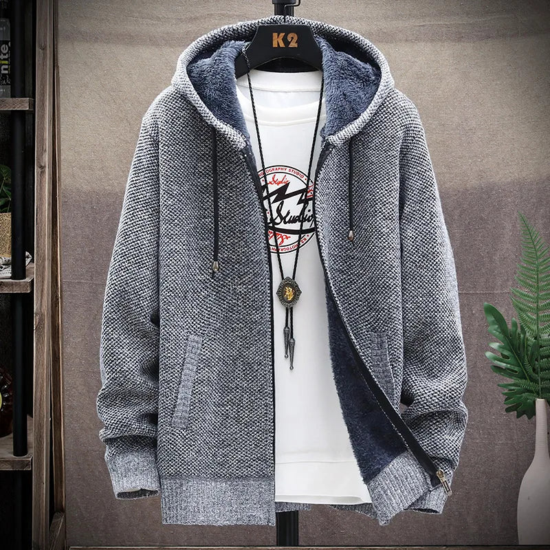 Gray hoodie on a mannequin with a white shirt underneath, against a neutral background.