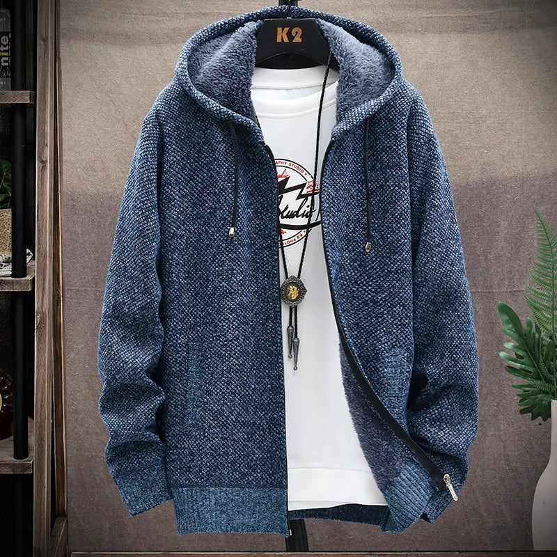 Blue hoodie with a white shirt underneath on a gray background