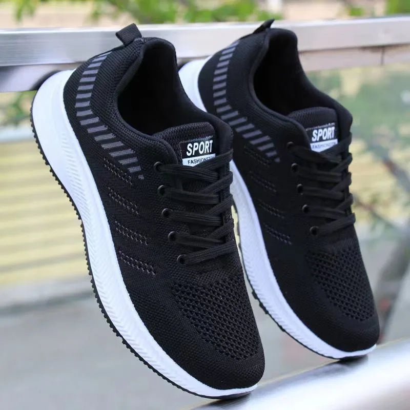 Black Men’s Casual Slip-On Sneakers with white soles on a blurred background