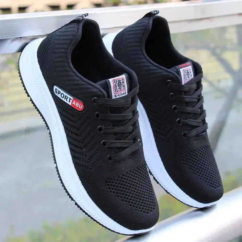 Black Men’s Casual Slip-On Sneakers with white soles on a blurred background