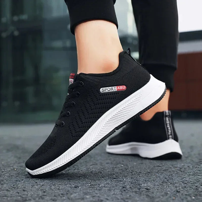 Black Men’s Casual Slip-On Sneakers with white soles on a blurred background