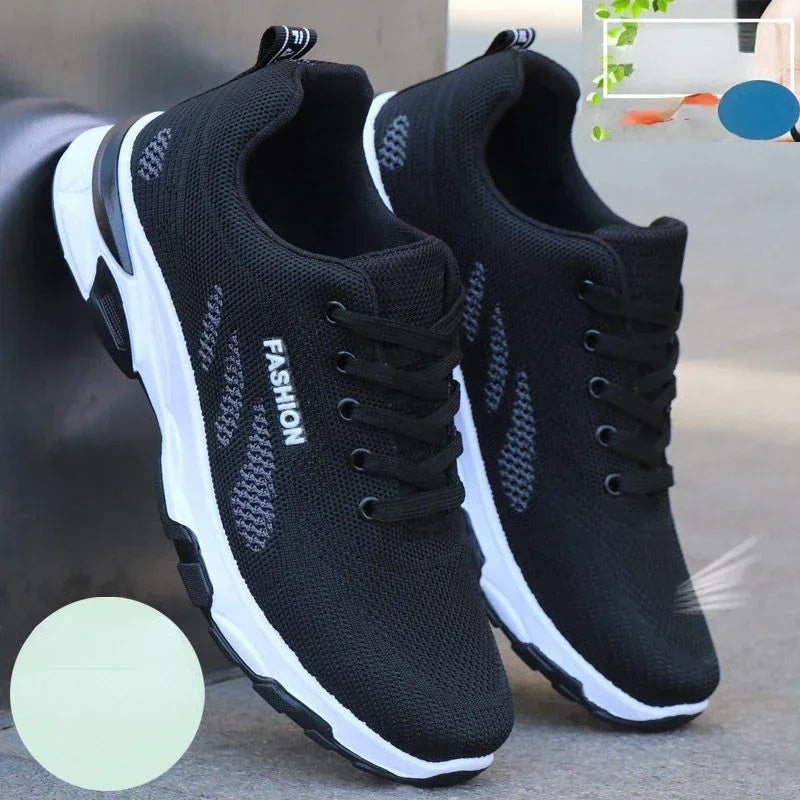 Black Men’s Casual Slip-On Sneakers with white soles on a blurred background