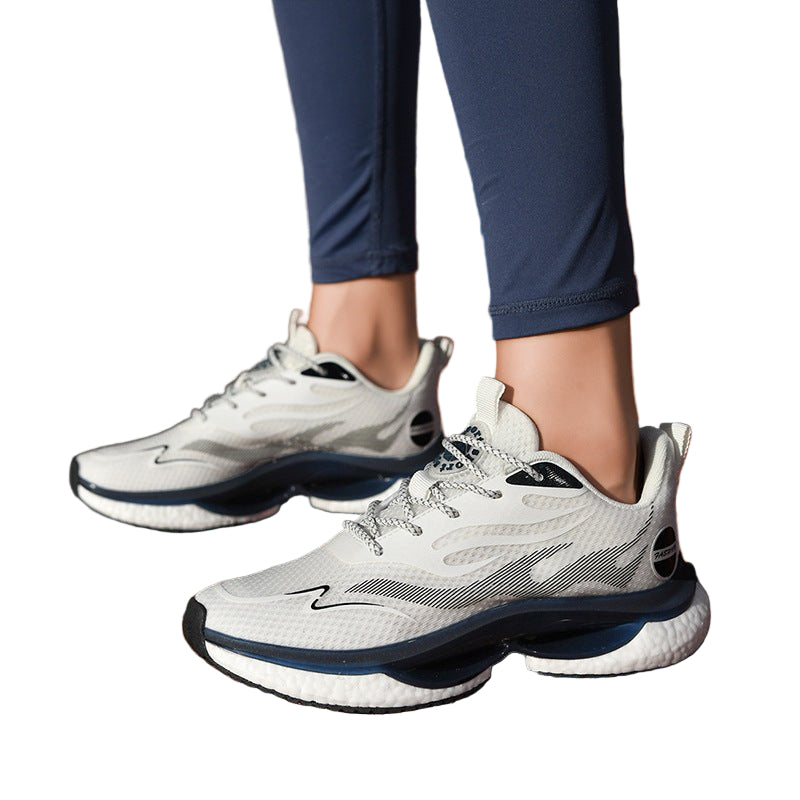 White running shoes with black soles on a track