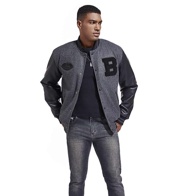 Man wearing a gray varsity American Baseball Jacket with a letter 'B' patch on a white background