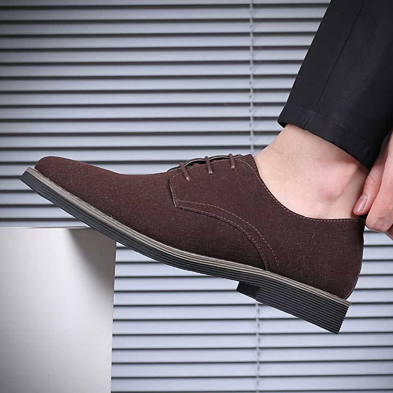 Brown suede shoe worn by a person against a neutral background